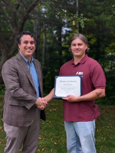 Kevin Prevost of Rumford-Mexico Sewerage District accepts his JETCC Management Candidate School certificate from Brett Willard.